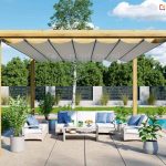 Pergola tarasowa drewniana juko wolnostojąca na tarasie przy basenie, dach rzymski chroni jasne meble z błękitnymi poduszkami przed promieniowaniem słonecznym.