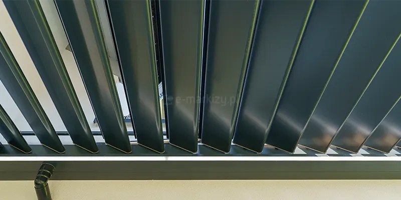 Zbliżenie paneli lamelowych dachu do pergoli SB400 R Selt. Specjalne profilowanie lameli zapewnia skuteczne odprowadzenie wody z dachu do bocznych rynien, ukrytych w ramie dachu.