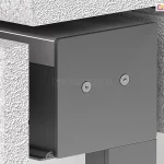 Zbliżenie techniczne na montaż podtynkowy kasety refleksola 120 Ziiip Selt w warstwie termoizolacji budynku. Zdjęcie prezentuje boczną pokrywę (boczek) kasety w kolorze antracytowym, przymocowaną dwiema śrubami z gniazdem typu torx. Kaseta jest precyzyjnie osadzona w wycięciu wykonanym w białym styropianie o wyraźnej strukturze granulatu. Konstrukcja ukazuje sposób integracji systemu osłonowego z elewacją, gdzie górna i boczna część obudowy stykają się bezpośrednio z materiałem izolacyjnym, co pozwala na późniejsze ukrycie mechanizmu pod tynkiem. W dolnej części widoczny jest profil prowadnicy.