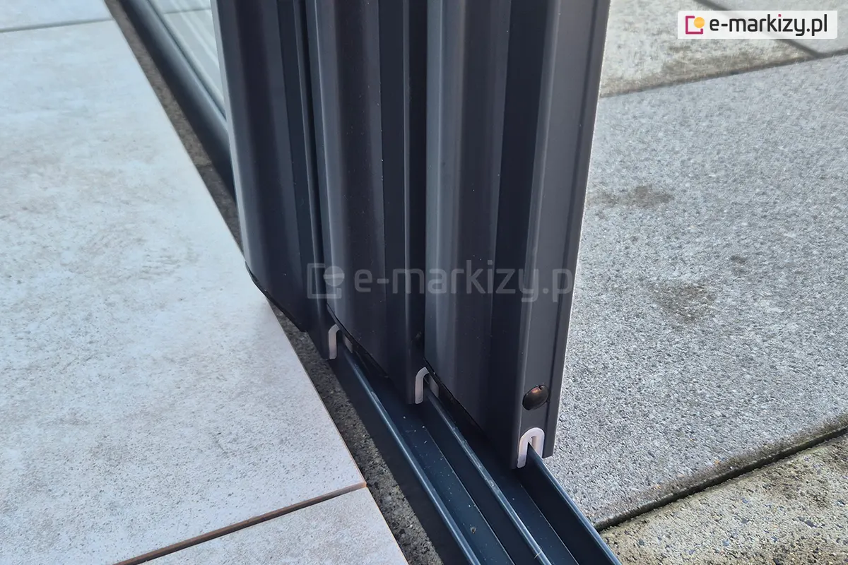 Zbliżenie na trzy aluminiowe panele systemu Sotro, każdy przesuwający się na osobnym torze i zsunięty razem w jedno miejsce.