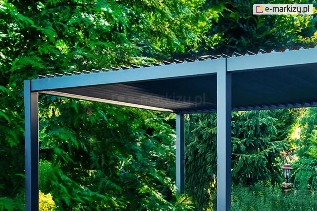Podwójna pergola aluminiowa Gloria z ruchomym dachem lamelowym zamontowana w ogrodzie, w otoczeniu drzew i bujnej zieleni. Bioklimatyczna zabudowa tarasowa idealna do relaksu w ogrodzie, z trwałym aluminiowym stelażem i systemem wentylacji przez dach.