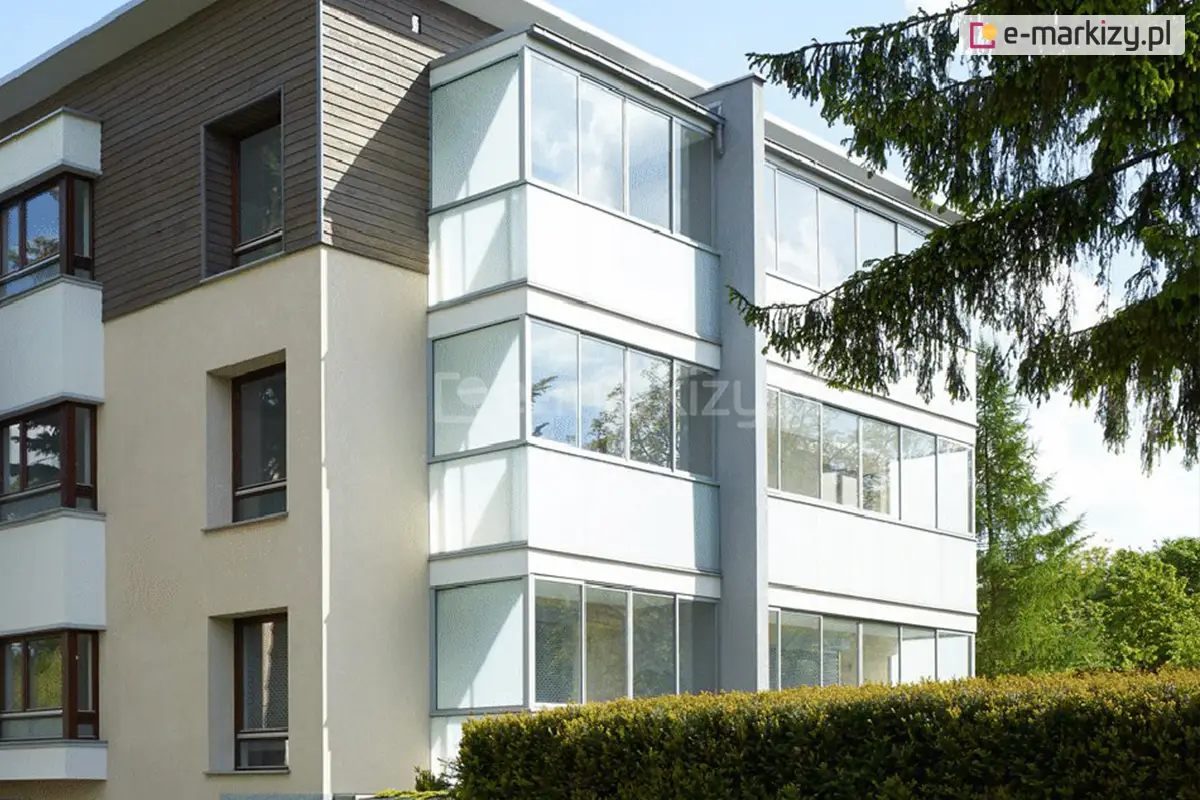 Zabudowane balkony w bloku mieszkalnym z zastosowaniem przeszkleń przesuwnych Sotro – estetyczne i funkcjonalne osłony szklane w kolorze dostosowanym do elewacji bloku.